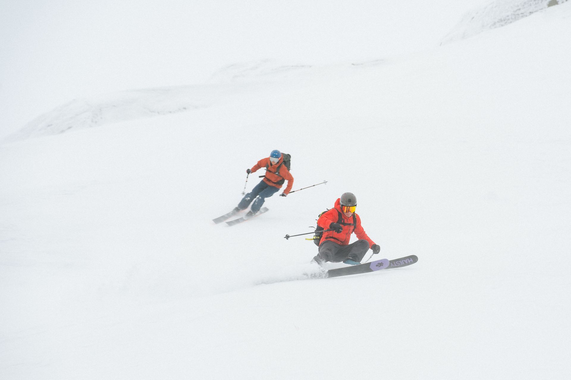 People skiing down from the top on a ski touring trip in Hardanger