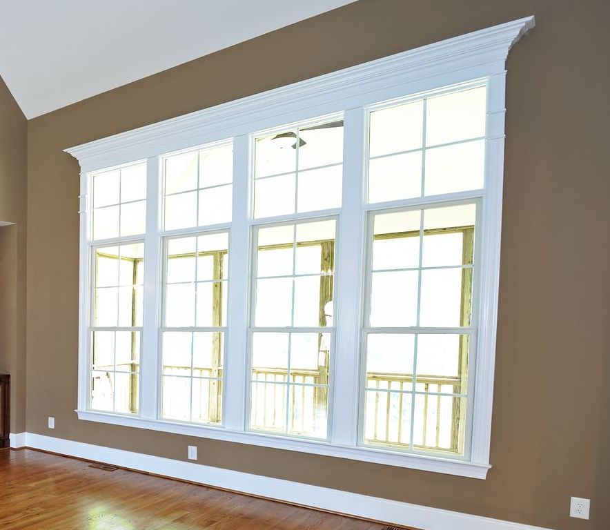 A man is installing a window in a room.
