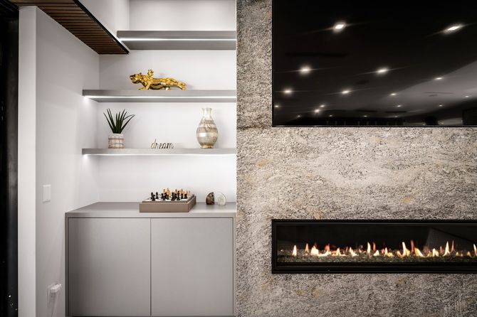 A living room with a fireplace and a flat screen tv.