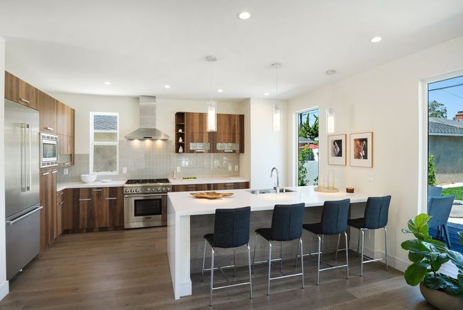 A kitchen with stainless steel appliances and wooden cabinets