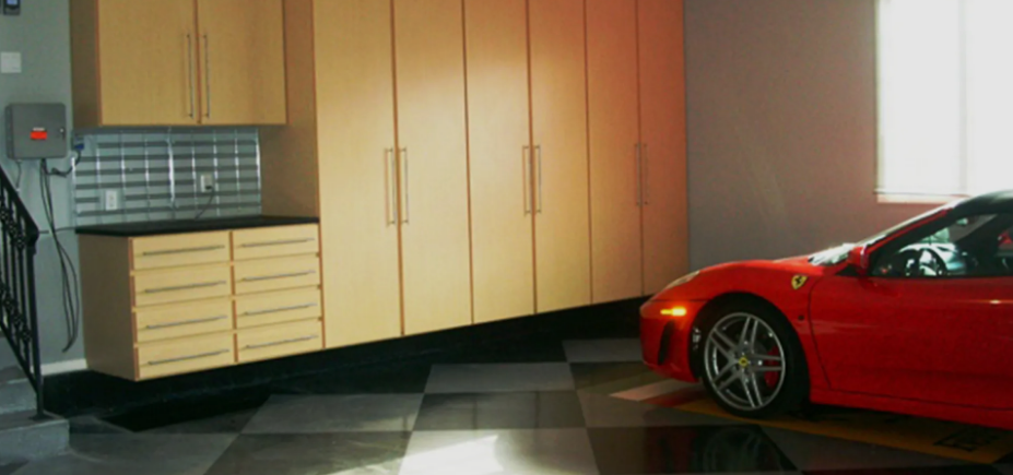 A red sports car is parked in a garage.