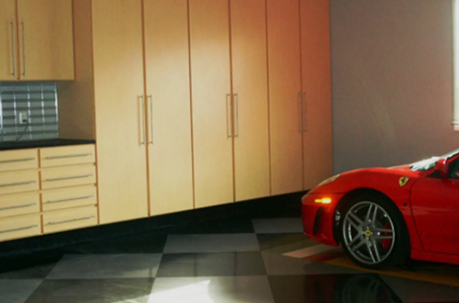 A red sports car is parked in a garage.