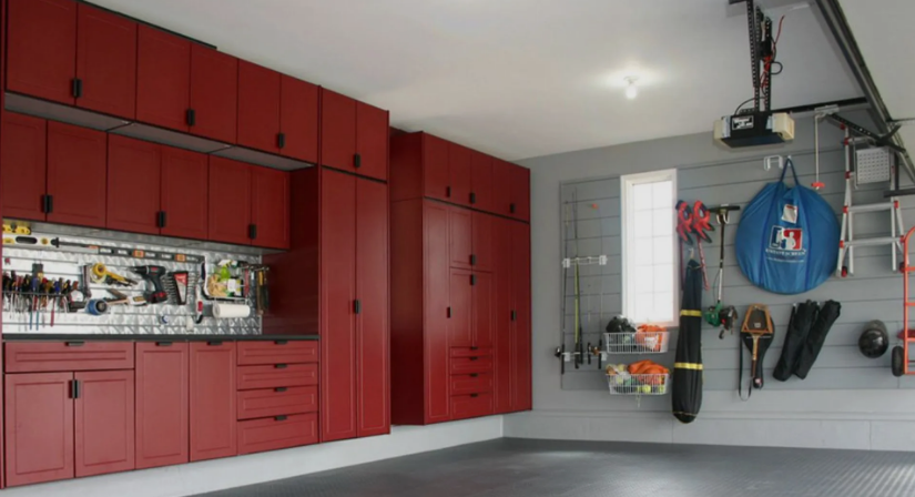 A garage with red cabinets and lots of tools