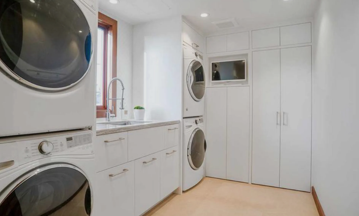 A white entertainment center with a flat screen tv
