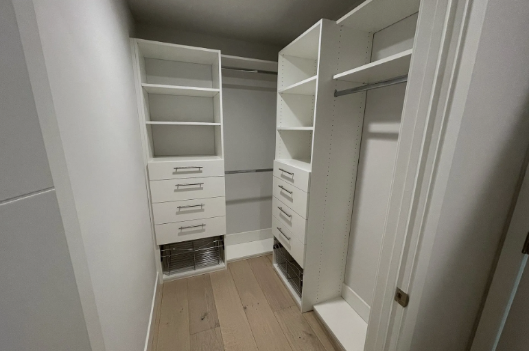 A kitchen with a long bar and stools