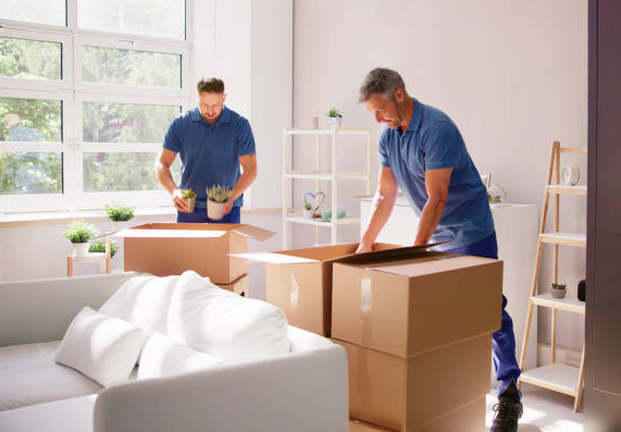 Men Putting Boxes On A Van — Newton, WI — Nomad Moving Services Men Putting Boxes On A Van — Newton, WI — Nomad Moving Services