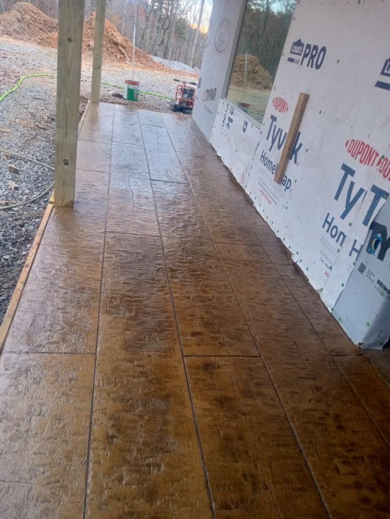 A concrete walkway leading to a building under construction.