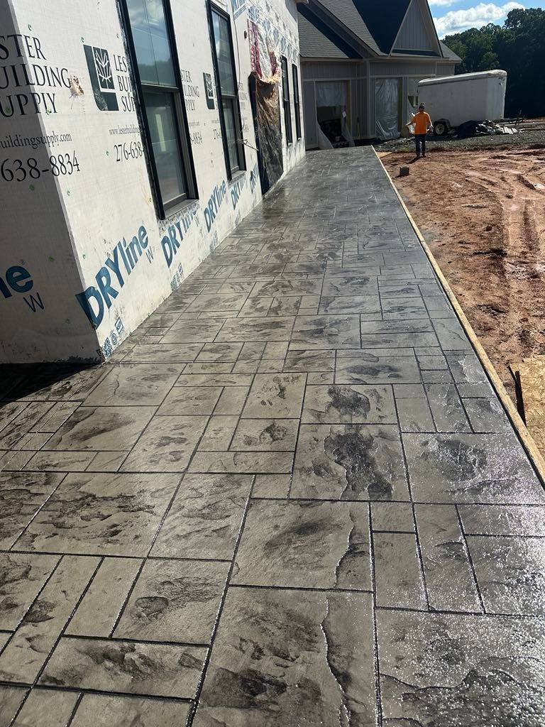 A concrete walkway is being built in front of a house.