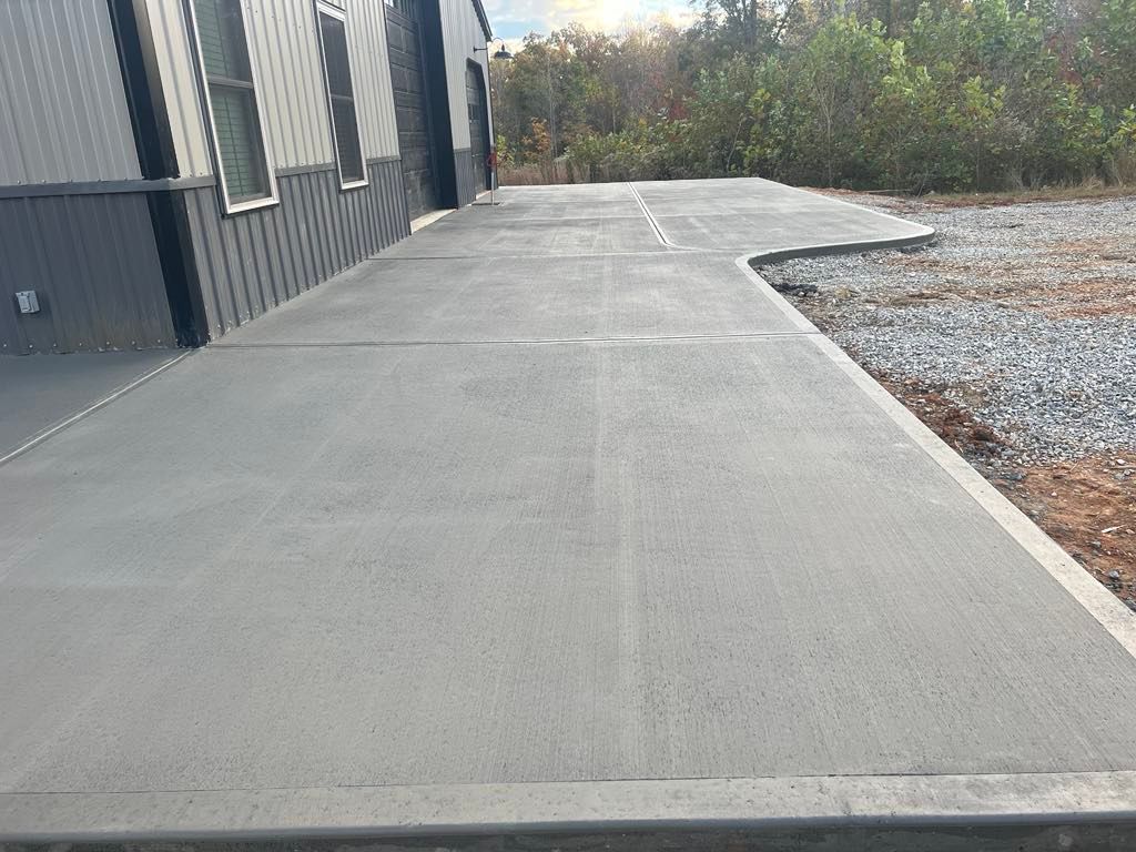 A concrete driveway is being built in front of a building.