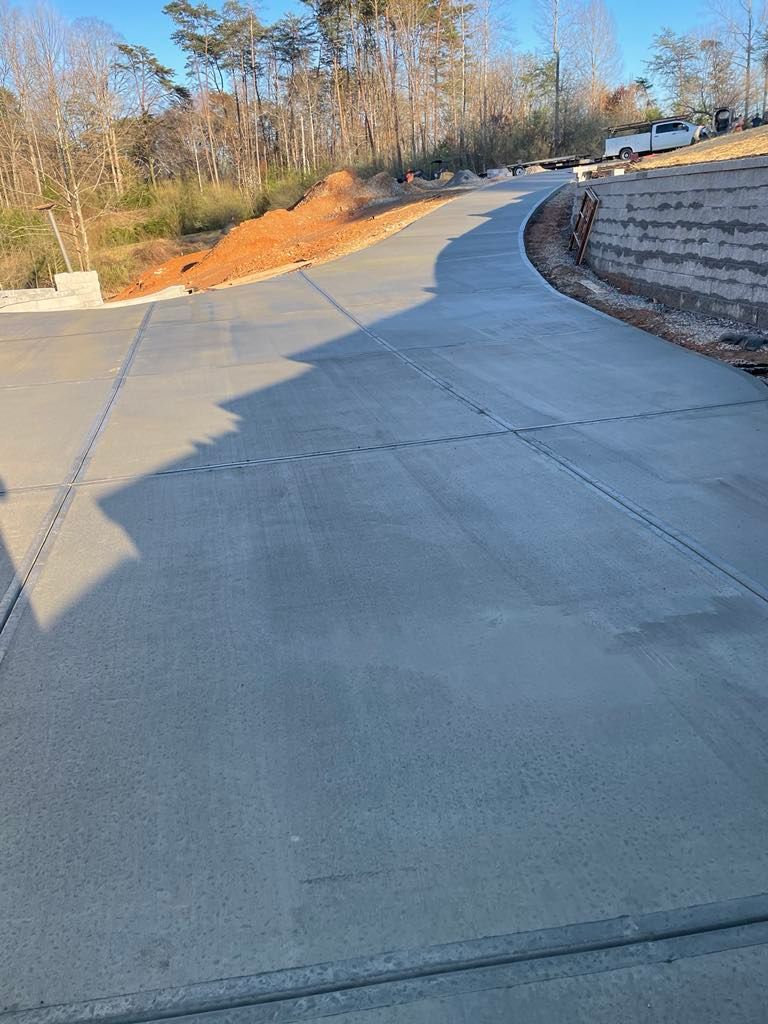 A concrete driveway is being built on a hill.