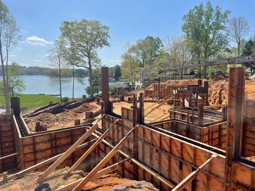 A construction site with a large body of water in the background.