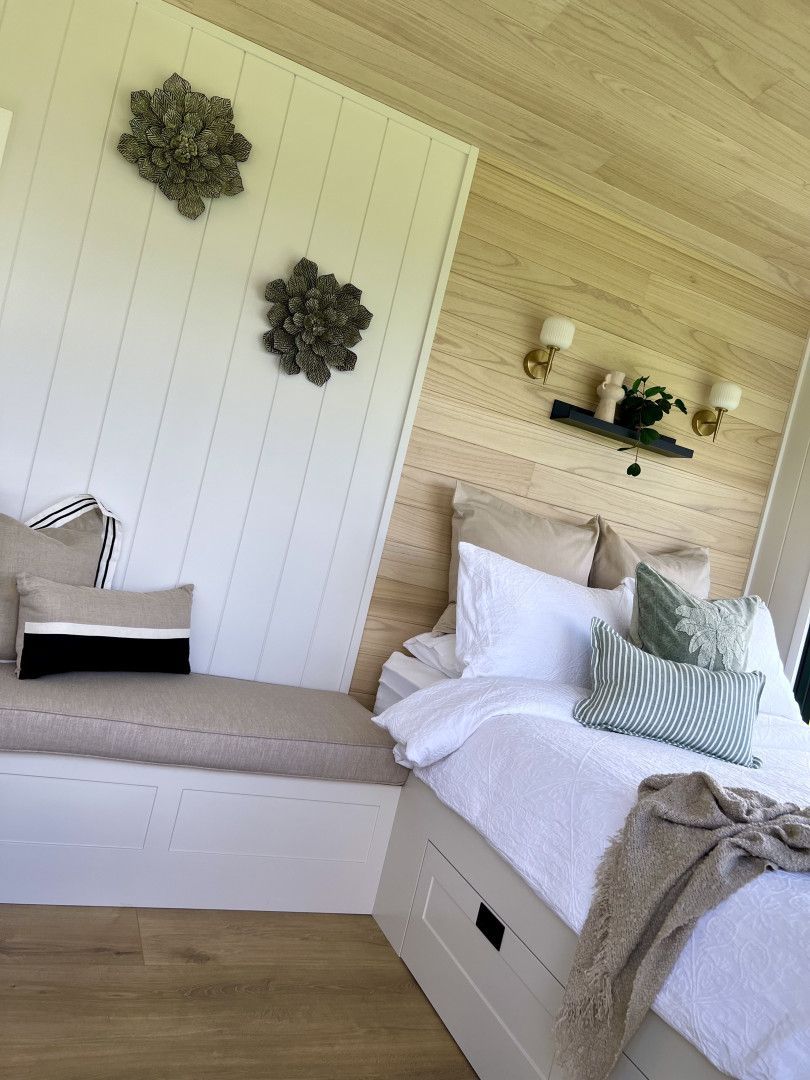 A Bedroom With a Bed and a Bench in the Corner — Highlands Tiny Homes In Braemar, NSW