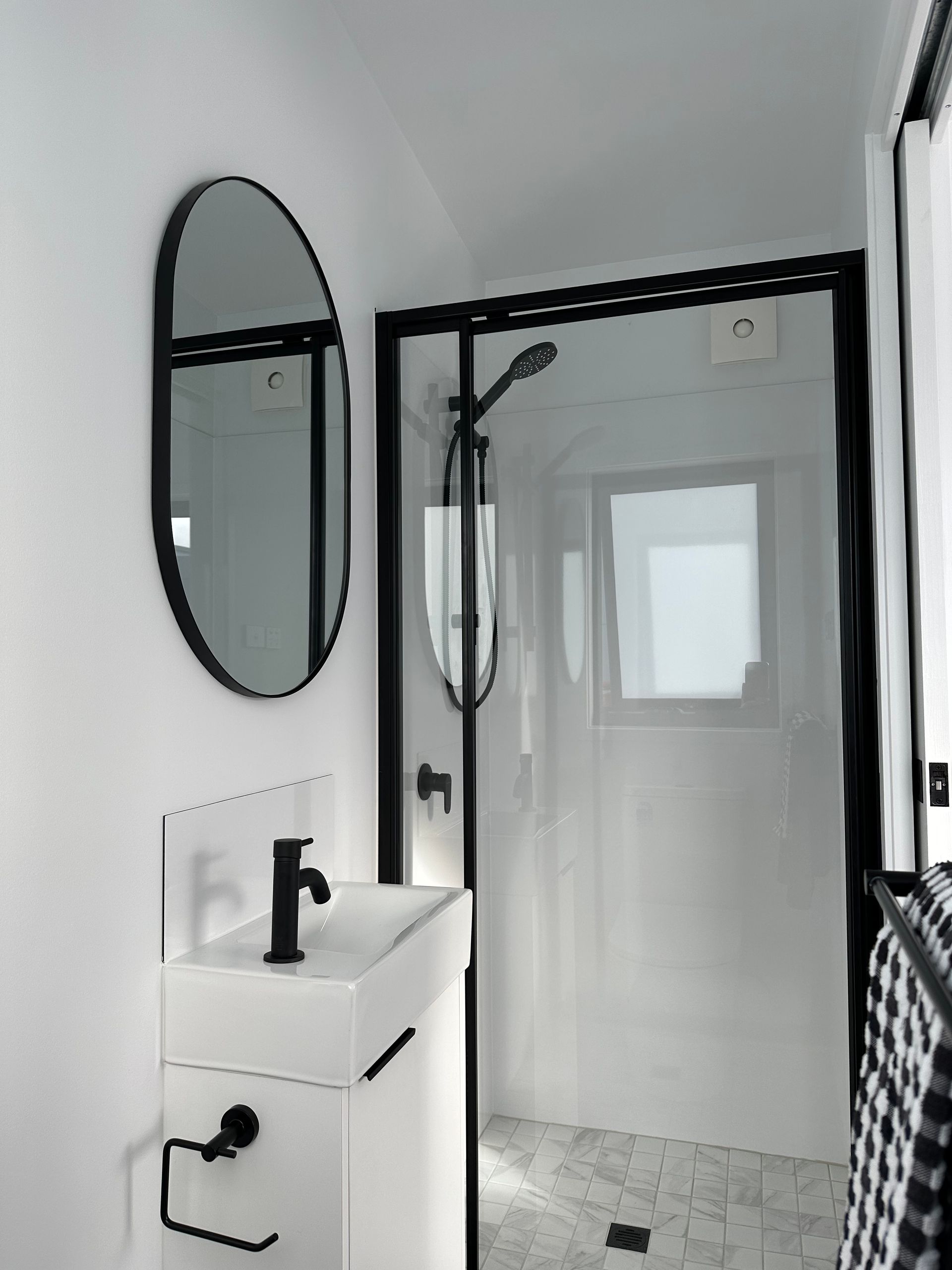 A Bathroom With a Sink a Mirror and a Shower — Highlands Tiny Homes In Braemar, NSW