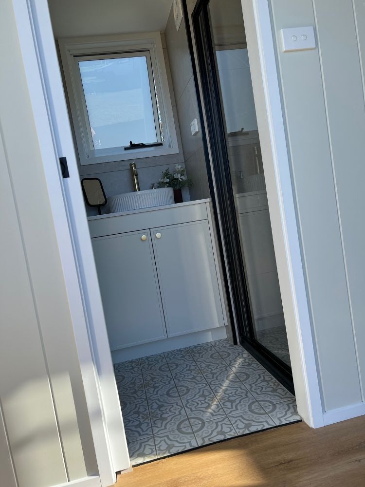 A Bathroom With a Sink and a Window — Highlands Tiny Homes In Braemar, NSW