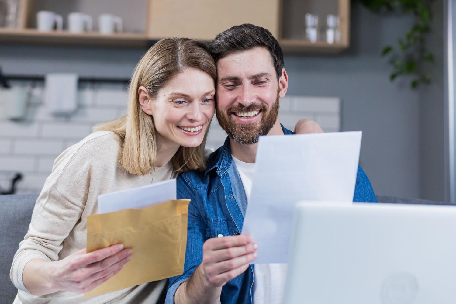 Financial advisor explaining documents to a couple at a table.