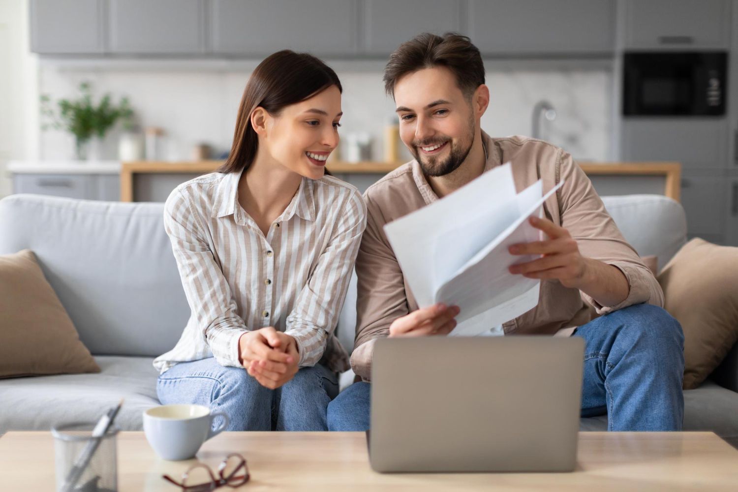 Financial advisor explaining documents to a couple at a table.