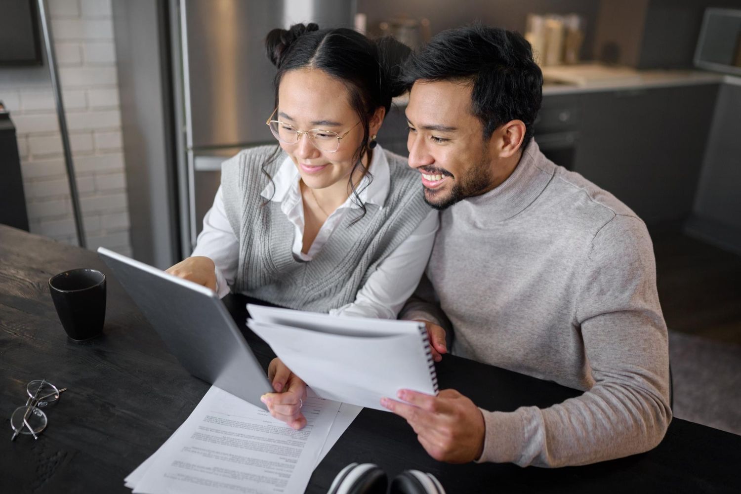 Financial advisor explaining documents to a couple at a table.