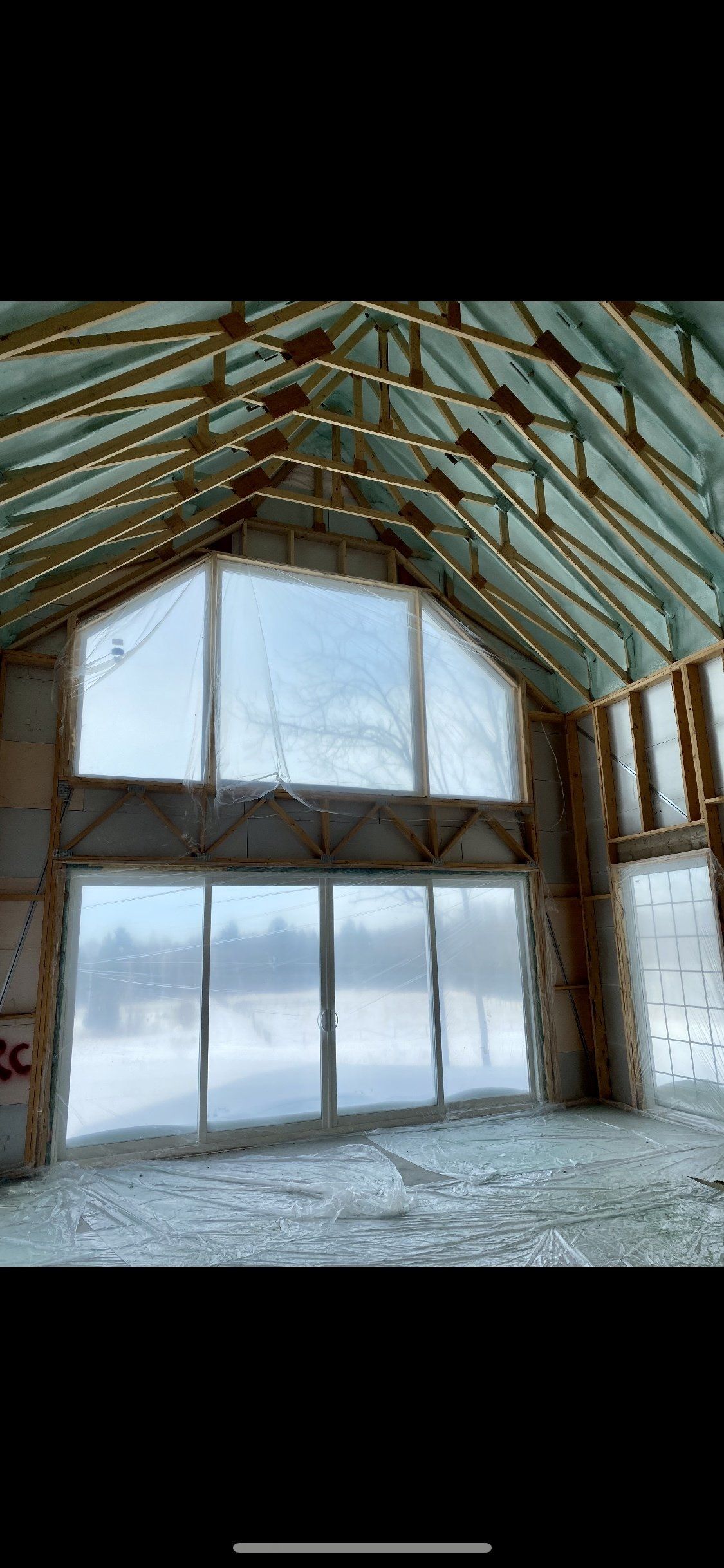 une grande pièce avec beaucoup de fenêtres et un toit.