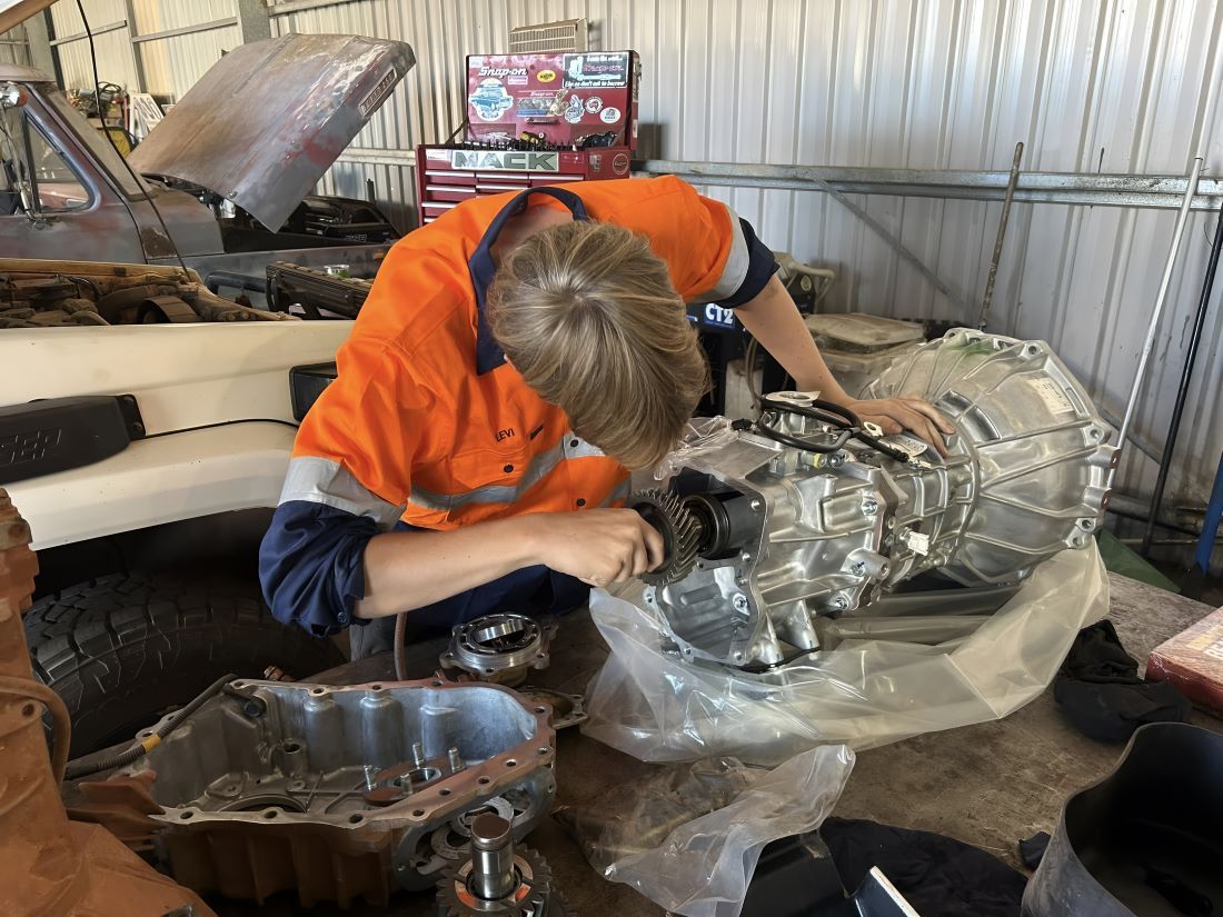 A Man is Working on a Car Engine in a Garage — Diesel Repairs in Alice Springs, NT