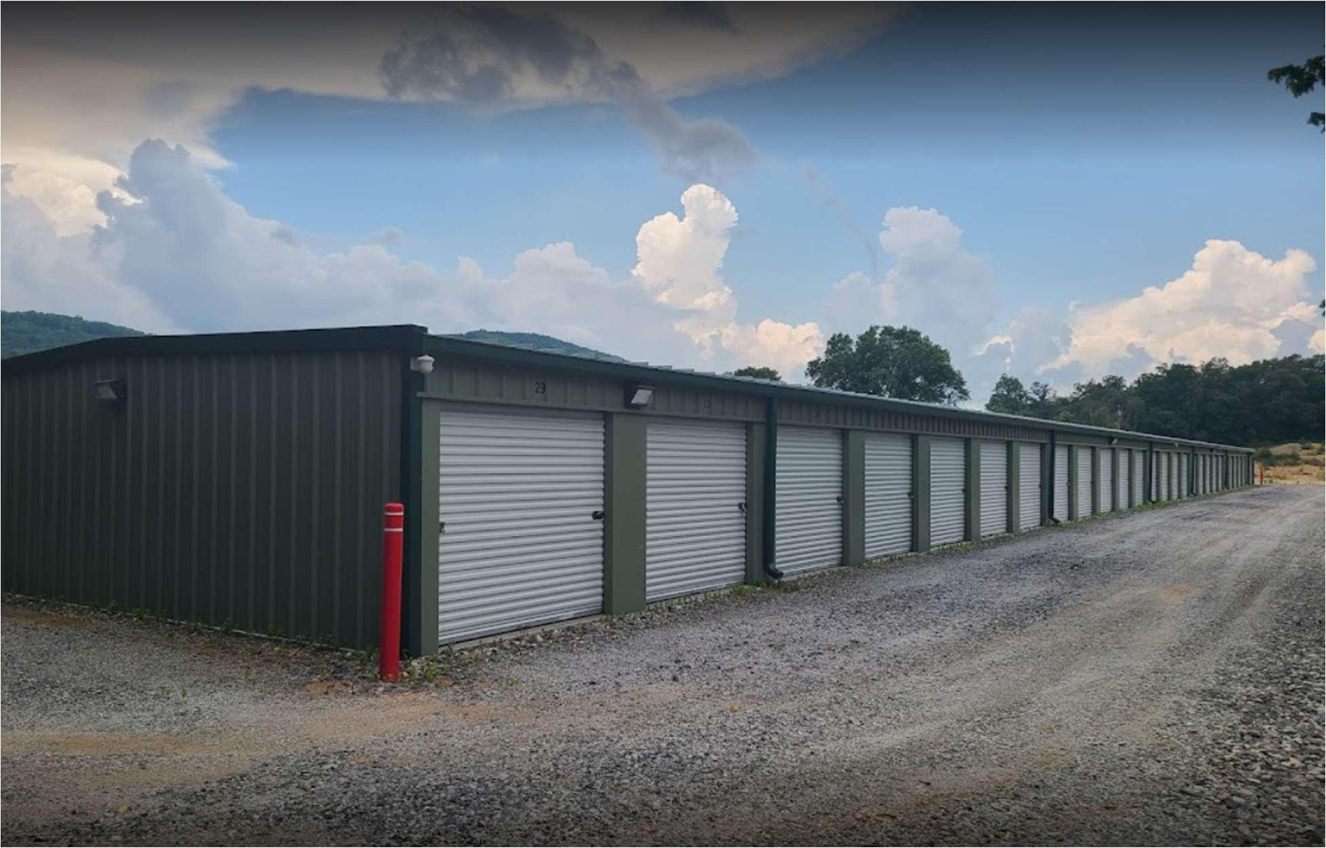 A row of storage units with blue doors filled with various items.