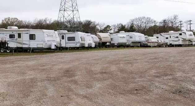 A row of caravans are parked in a warehouse.
