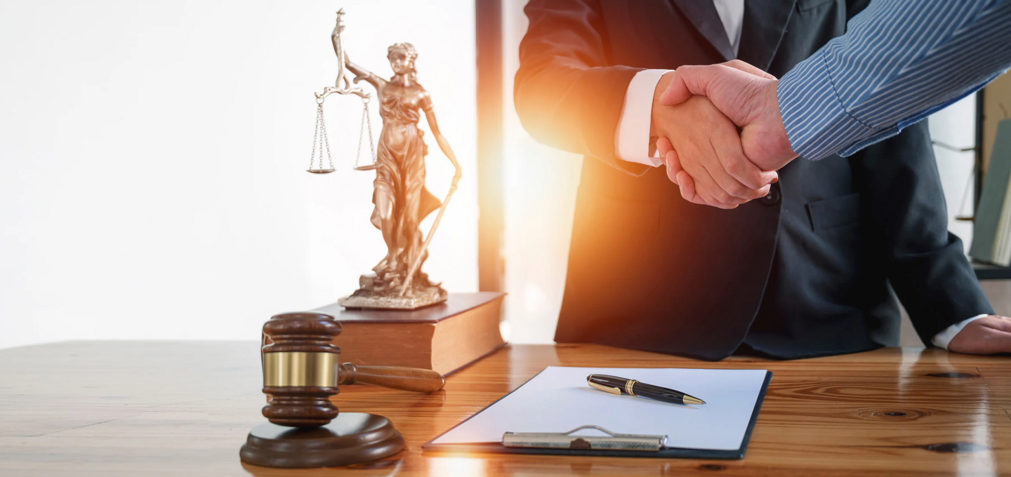 A LAWYER SHAKING HANDS WITH A CLIENT