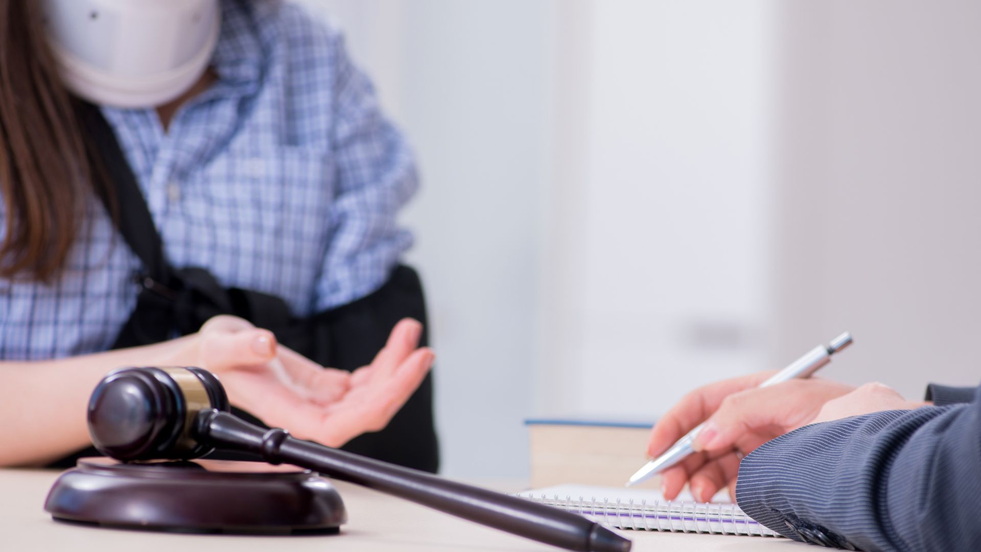 A man and a woman are sitting at a table with a judge 's gavel.
