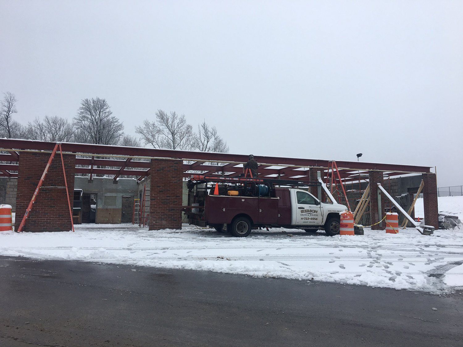 Industrial Welding — Truck With Ladder In Commercial Site in Westmoreland, NY