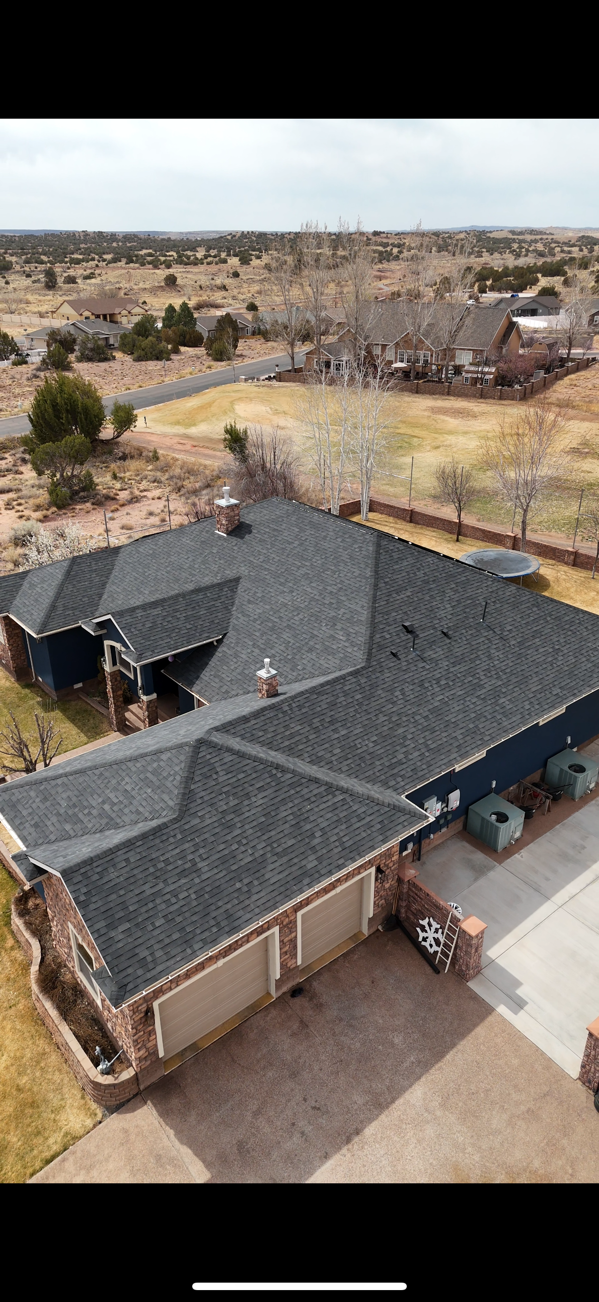 An aerial view of a house with a new roof.