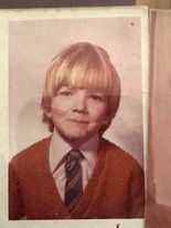 old colour photo of a young school boy. 