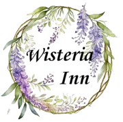 a logo for wisteria inn with purple flowers and green leaves