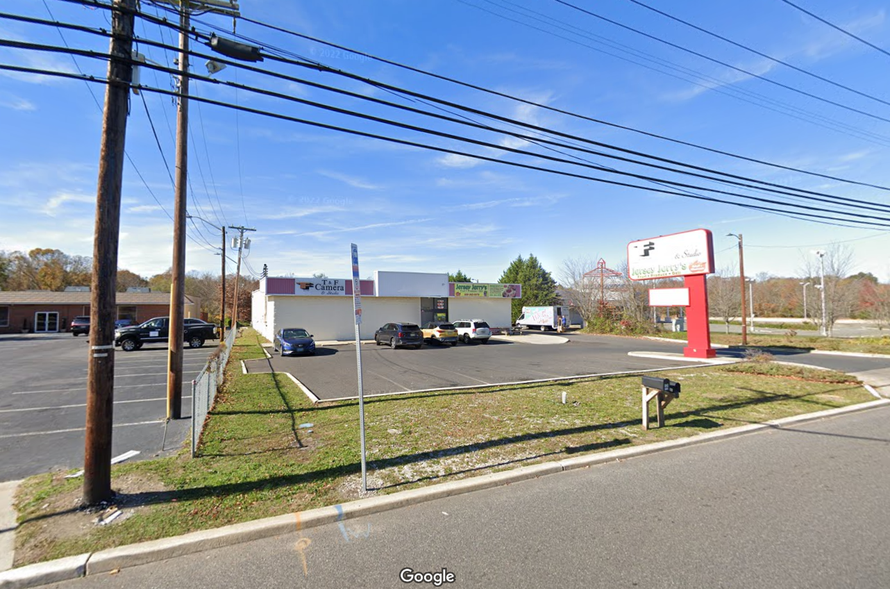 a parking lot with cars parked in front of a store .