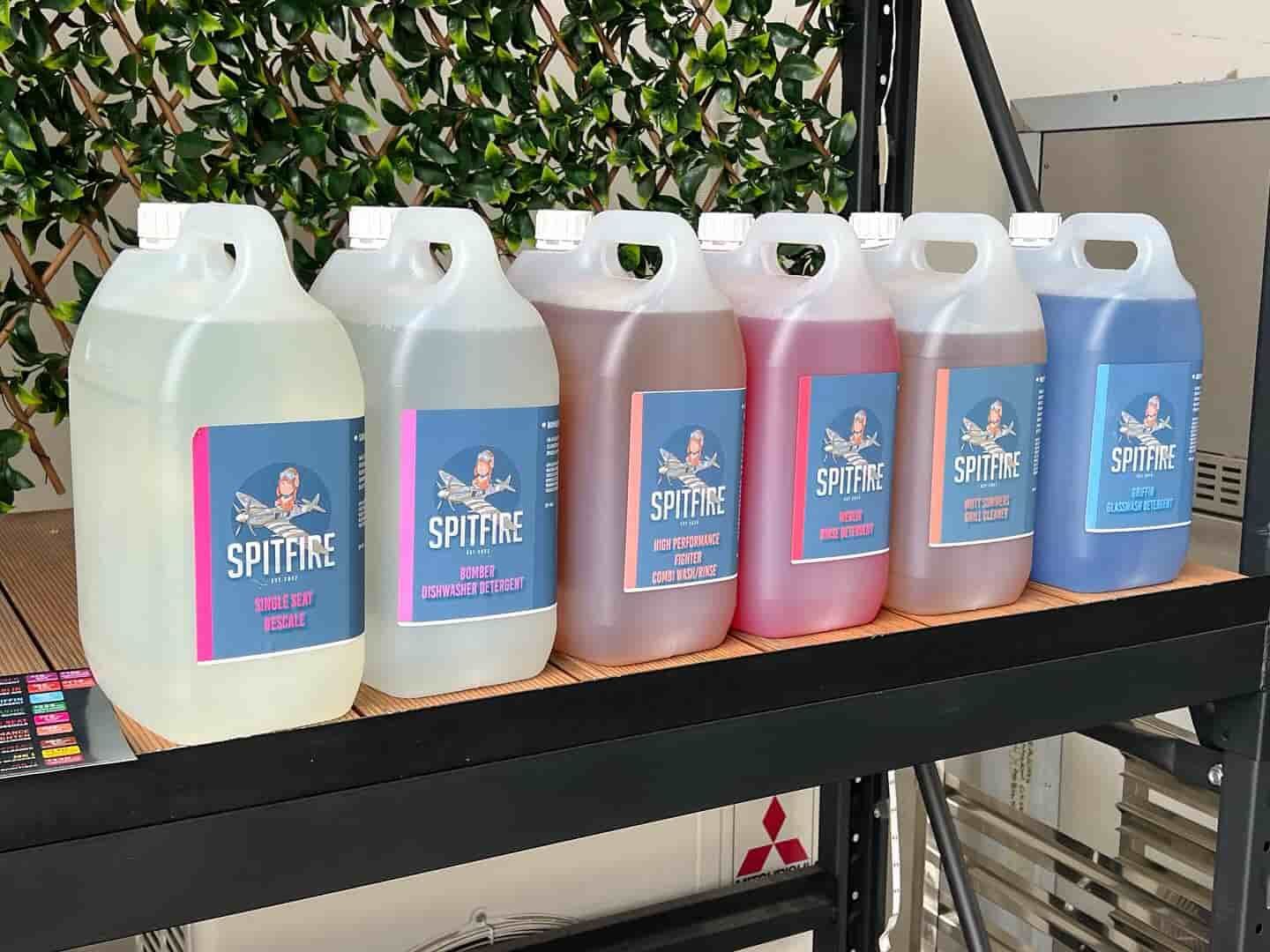 A Row of Bottles Sitting on Top of a Wooden Shelf — Spitfire Chemicals Pty Ltd in Rutherford, NSW