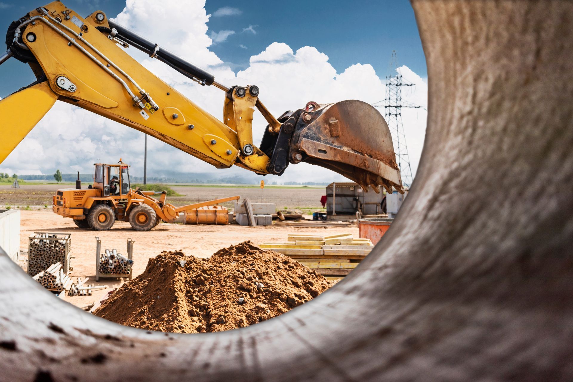 Construction equipment rental excavator working on large commercial construction project site. Construction equipment rental excavator working on large commercial construction project site.