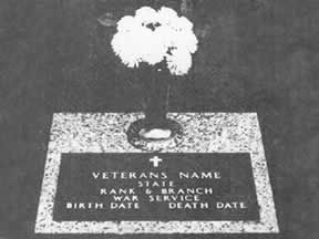Gravestone with flowers. The grave marker lists 
