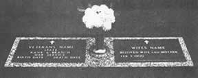 Gravestone with floral arrangement, divided into Veteran's and Wife's sections, black and white.