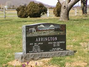 Tombstone with landscape painting, ARRIINGTON name, dates of birth and death, in a grassy field with a fence.
