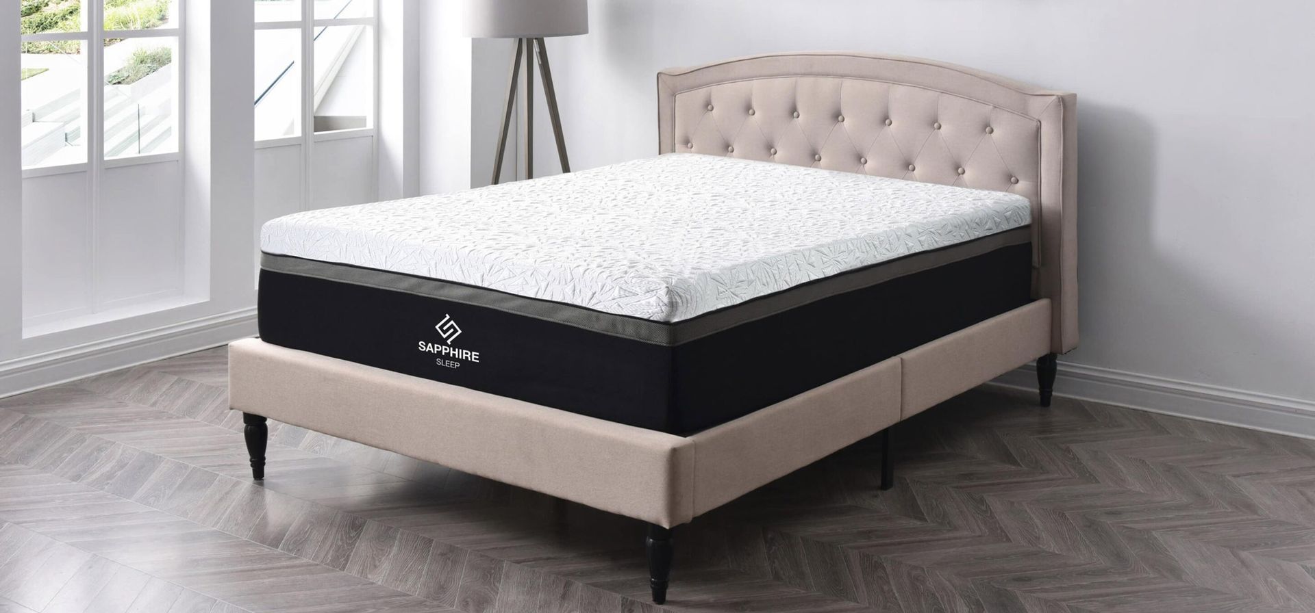 White and black Sapphire mattress, with a patterned top, on a platform.