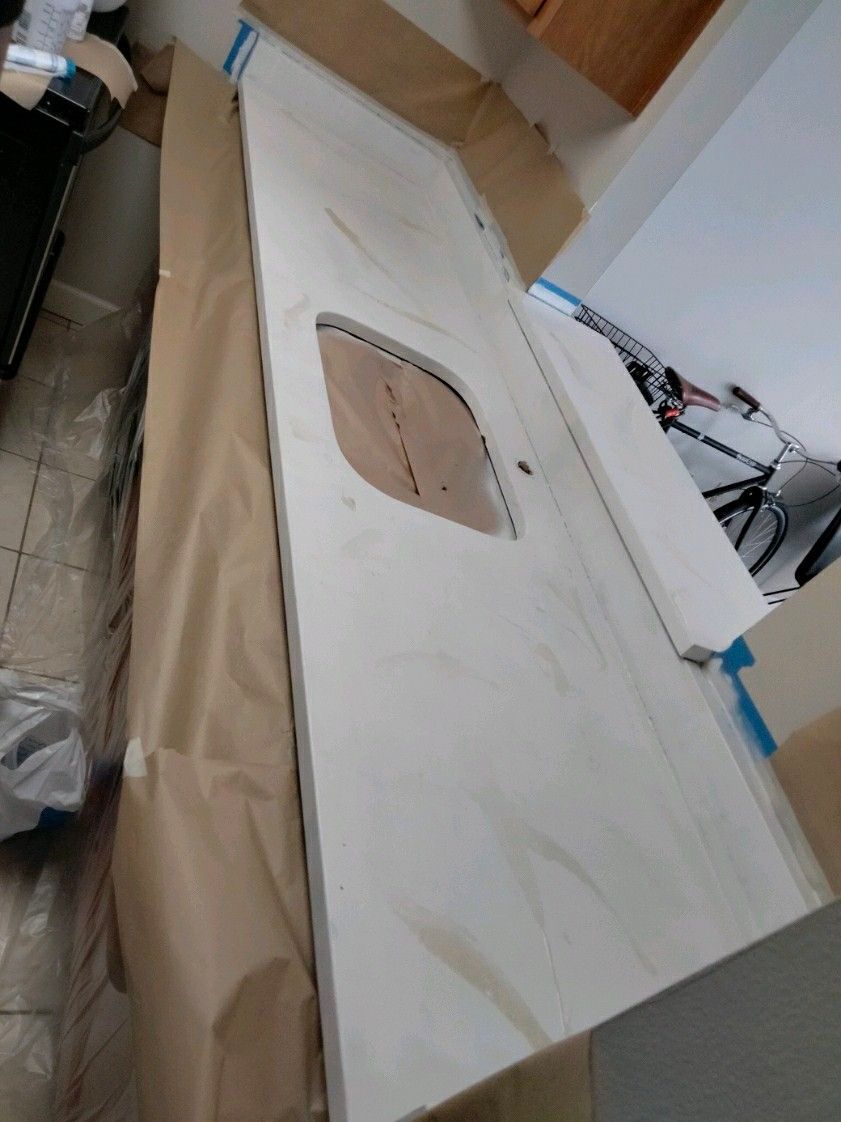 A white counter top with a hole in the middle