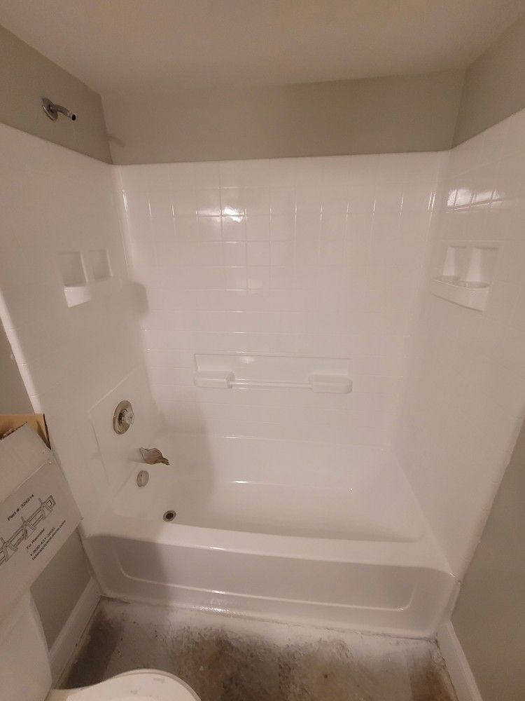 A bathroom with a bathtub and a toilet.