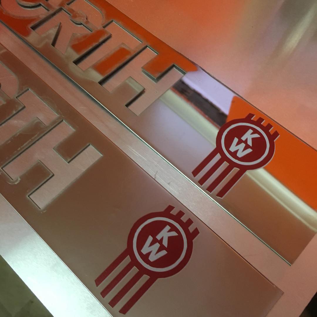 Precision-cut and UV-printed Kenworth logos on stainless steel using WaterJet technology for XPiggy Customs-CNC's unique creations — Laser Cutting in Unanderra NSW