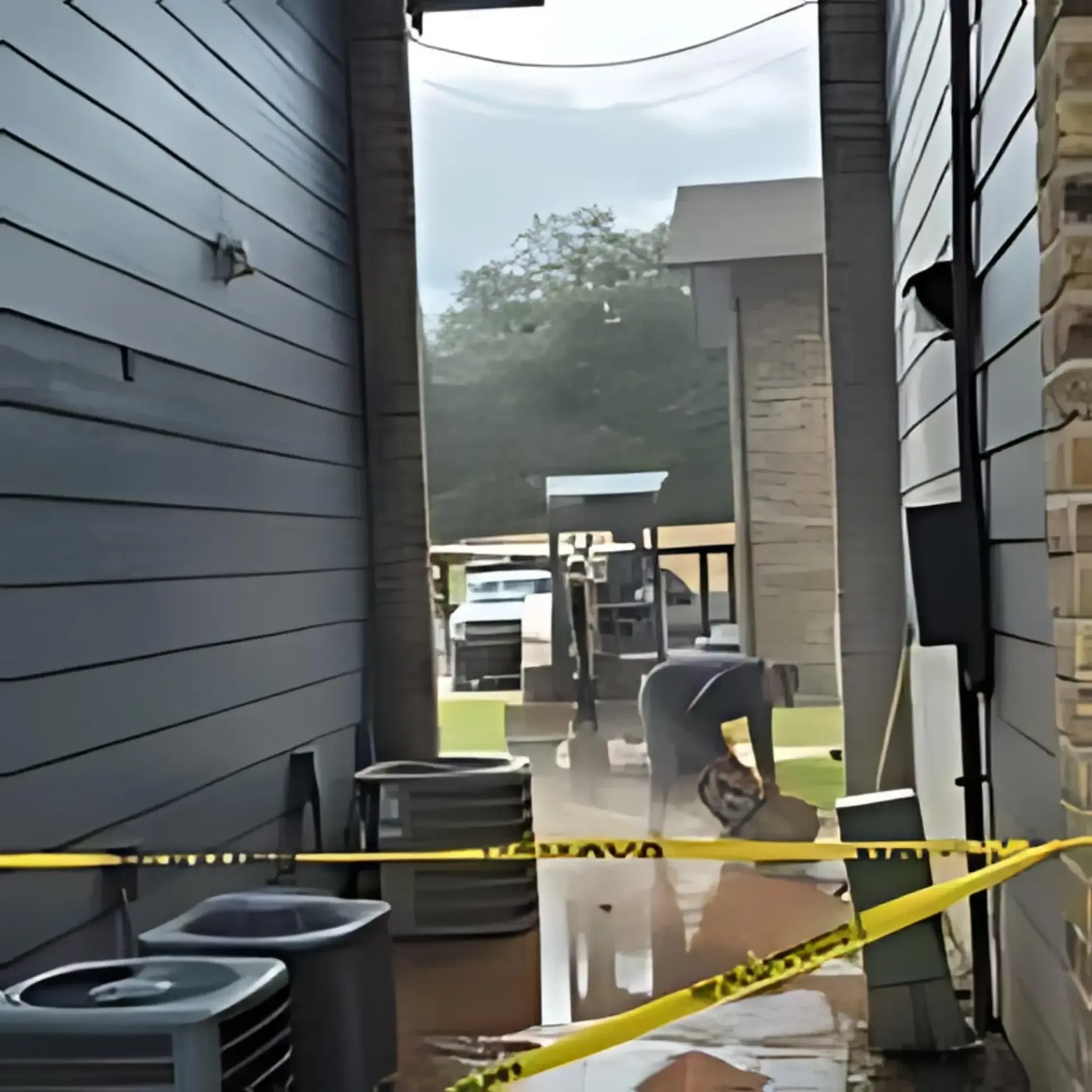 Castleberry's Plumbing LLC - A narrow alleyway with a yellow tape that says caution