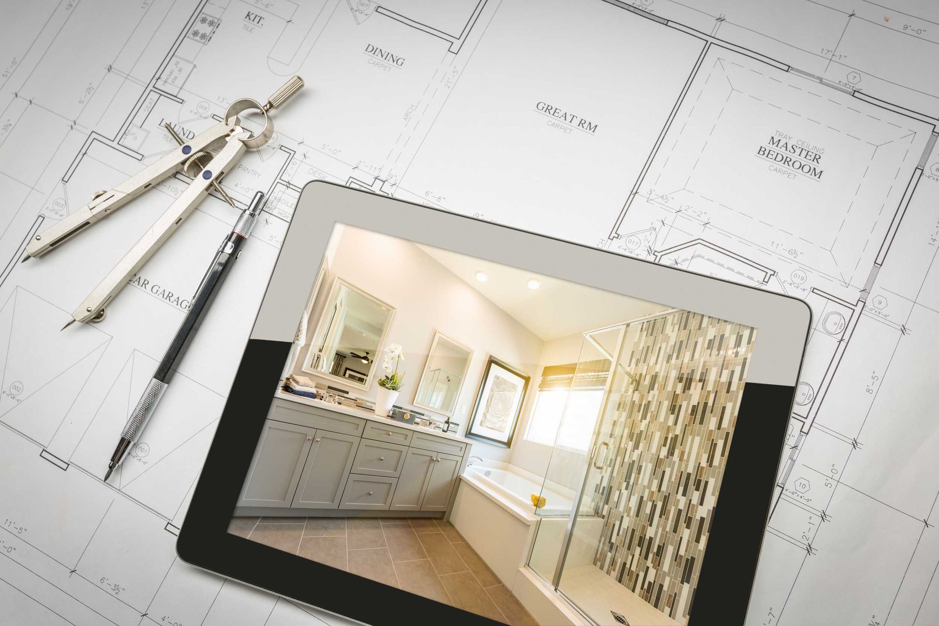 Tablet displaying a bathroom design placed on architectural floor plans with tools.