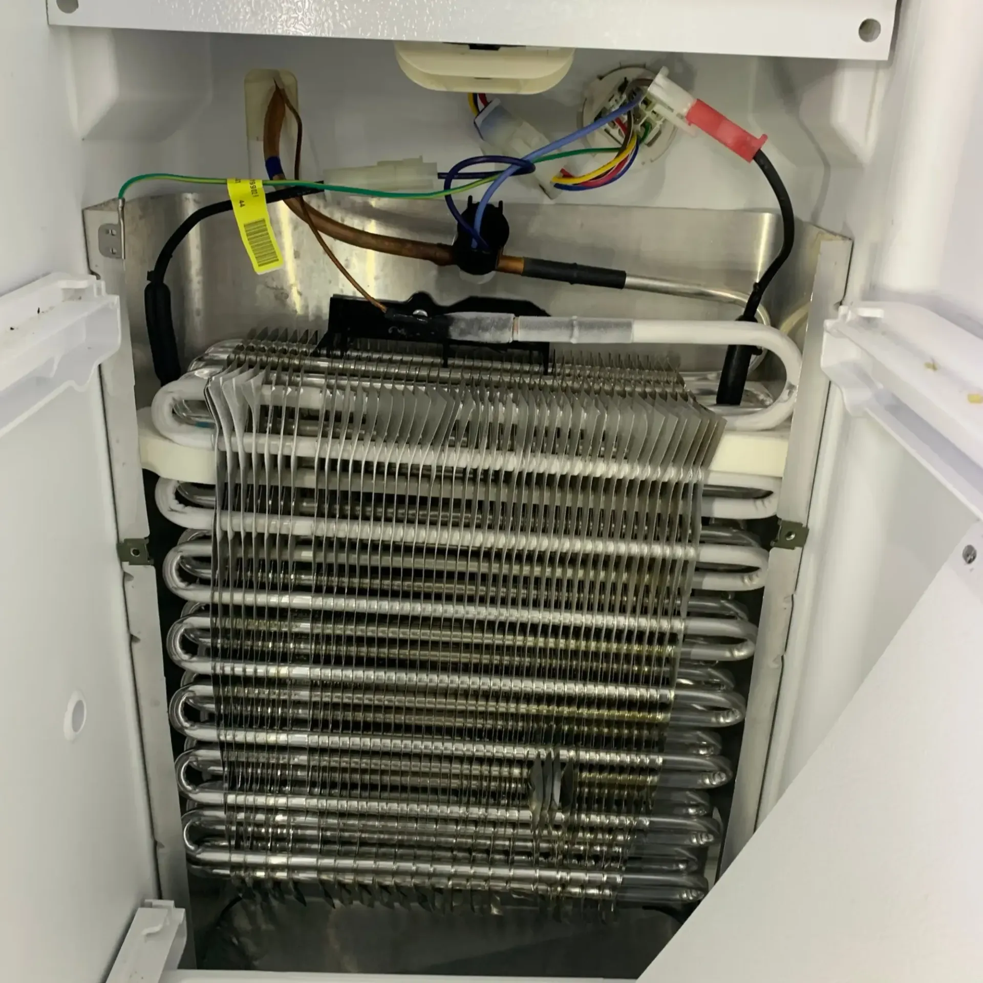 Appliance Tech- The inside of a refrigerator with the door open
