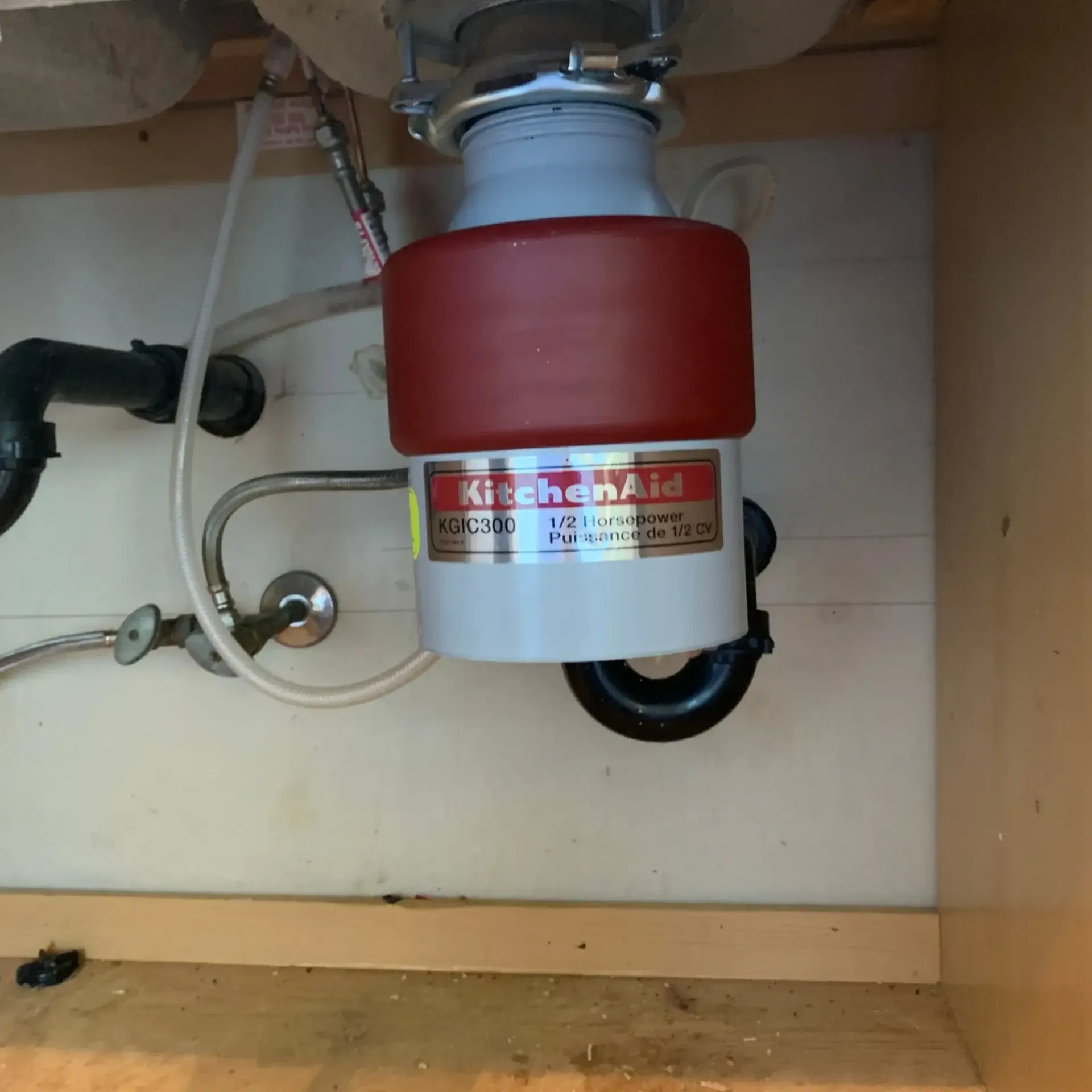 Appliance Tech- A kitchenaid garbage disposal is under a sink