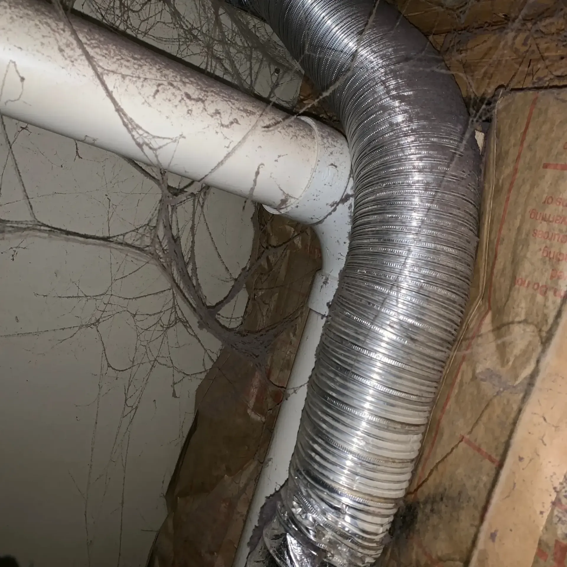 Appliance Tech- A hose is connected to a pipe in a room.