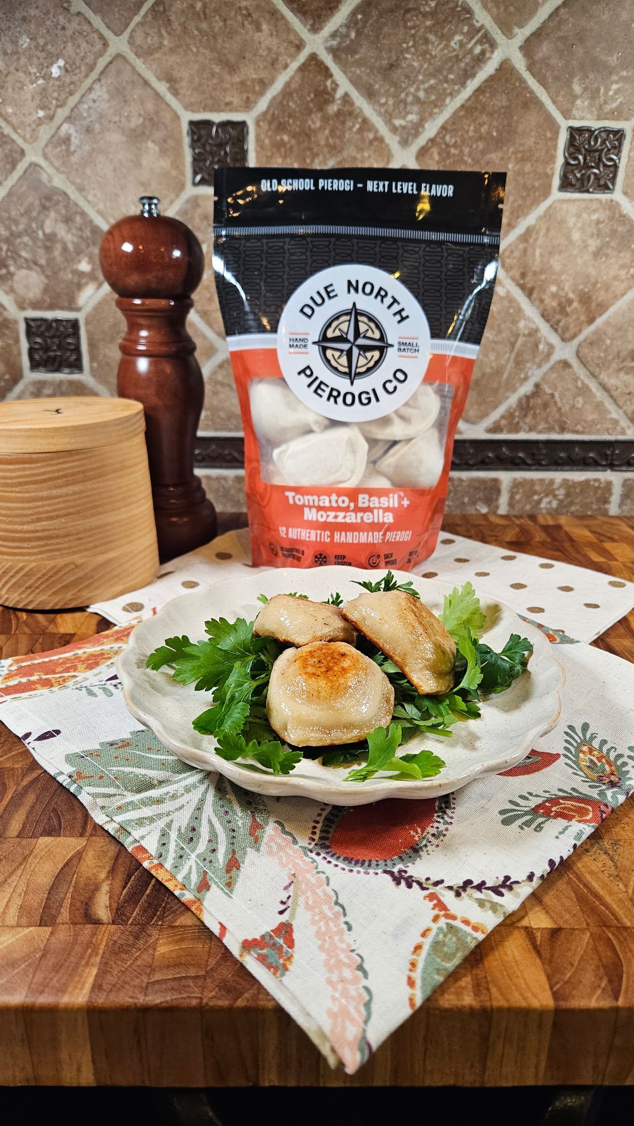 A bunch of bags of pierogi are stacked on top of each other