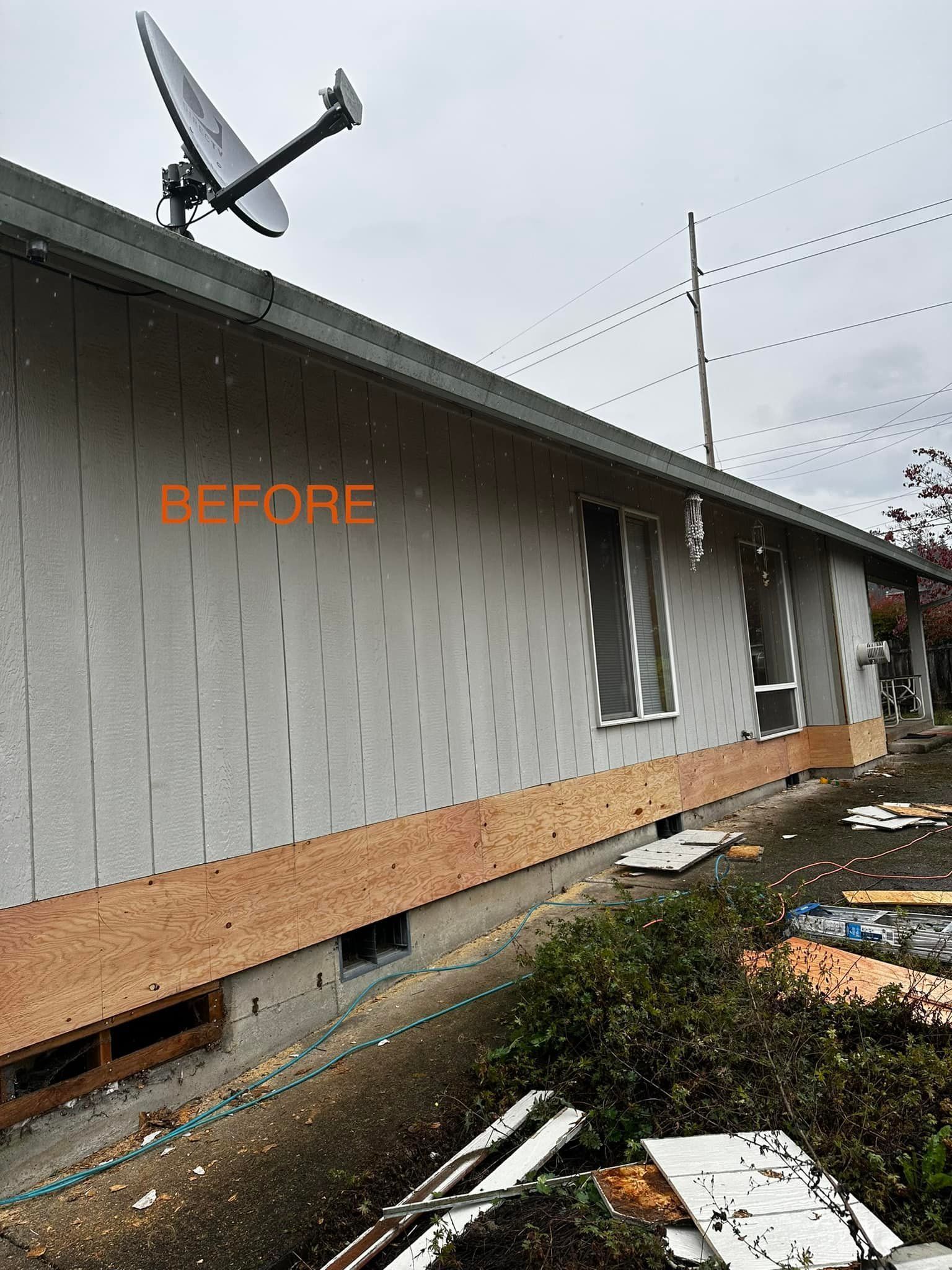 A before picture of a house with a satellite dish on the roof.