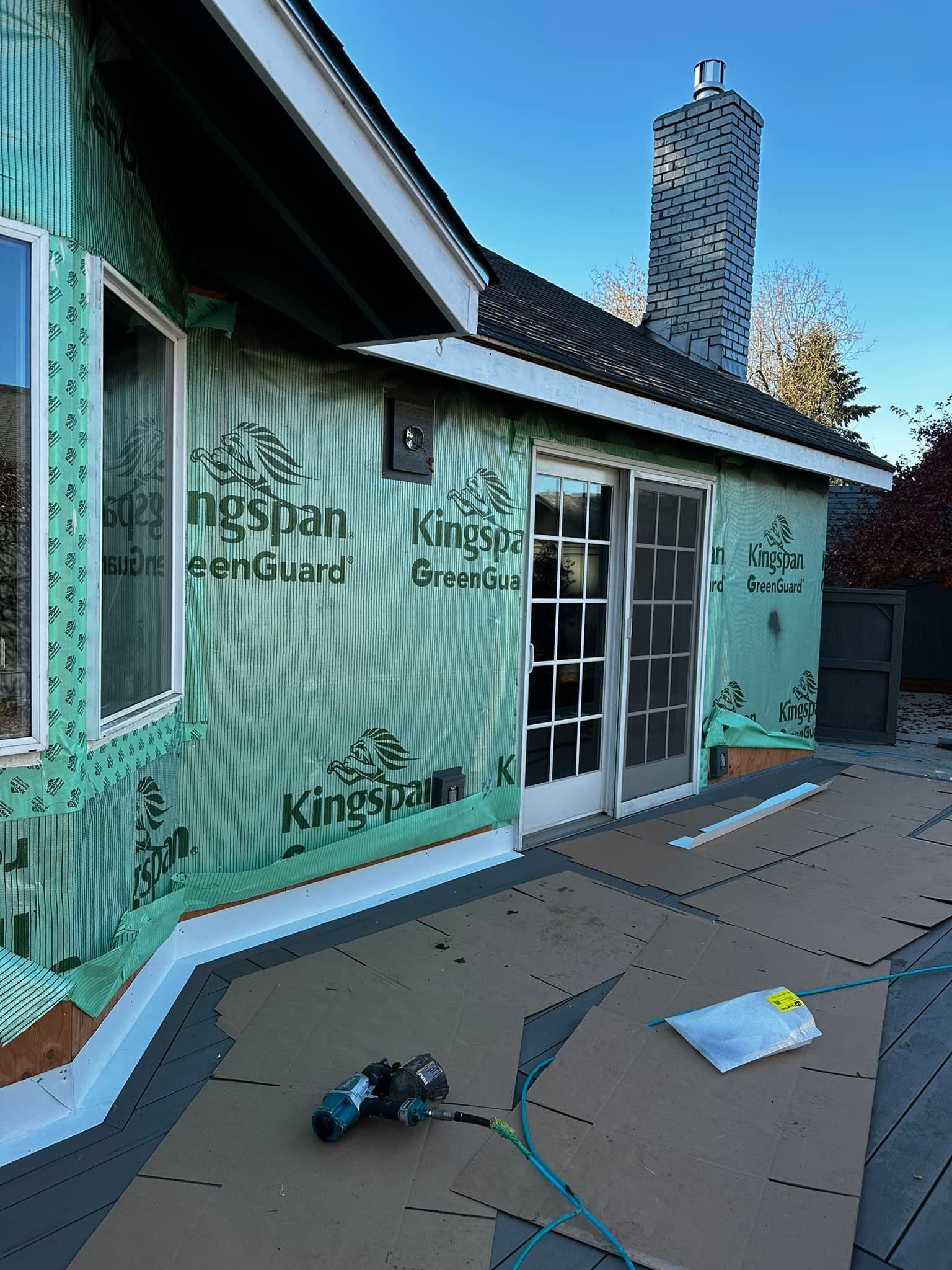 A house is being insulated with green styrofoam.