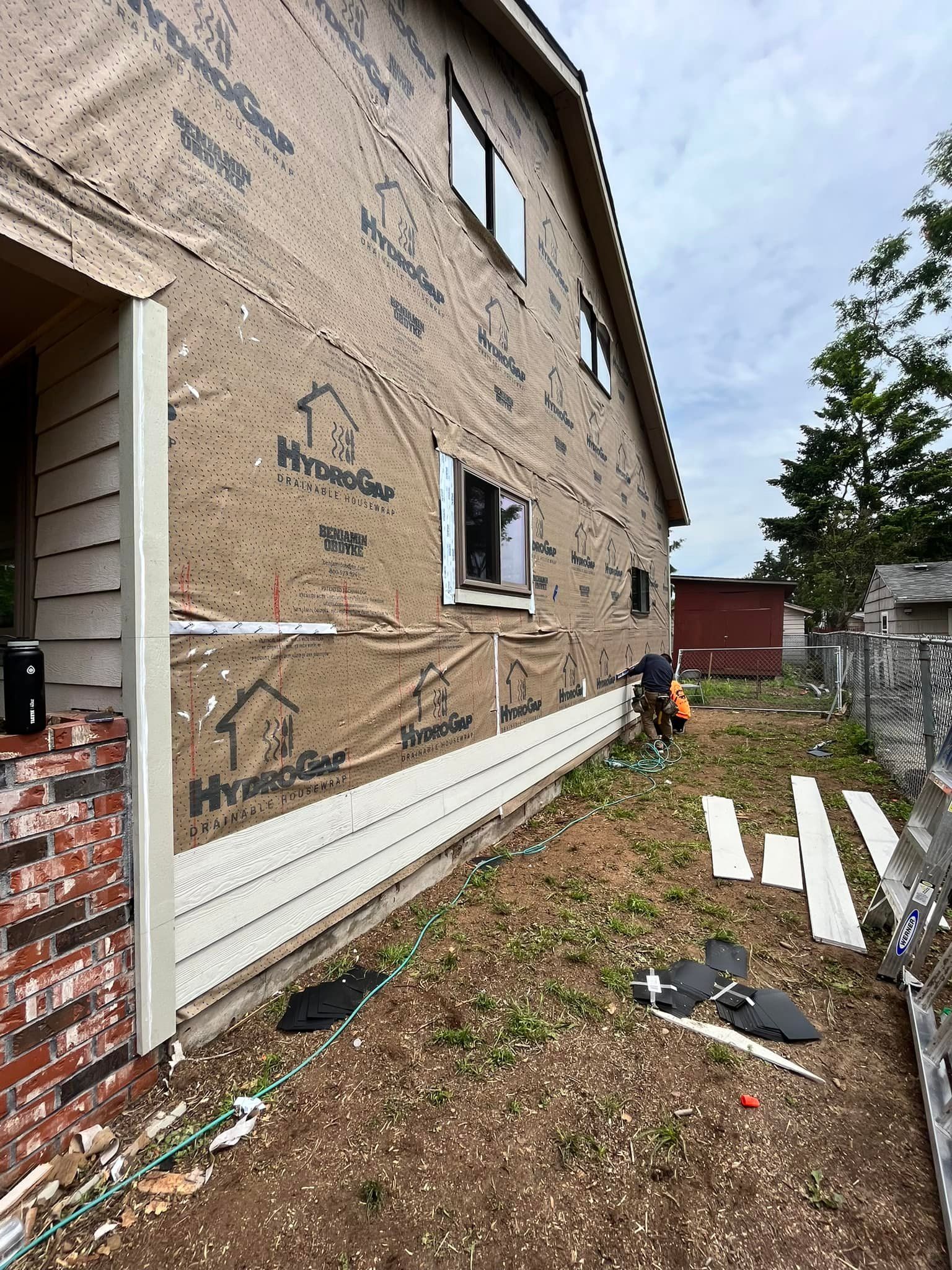 A house is being built with a lot of siding on it.